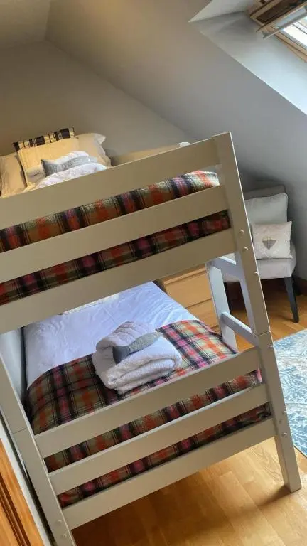 a bunk bed with towels on the bottom bunk at Beautiful dog friendly lodge with hot tub in Aboyne