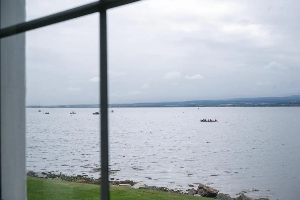 a view of a large body of water from a window at Linden House in Fortrose