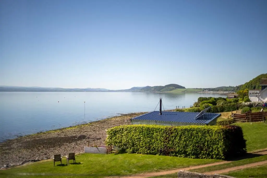 a house on the shore of a body of water at Linden House in Fortrose