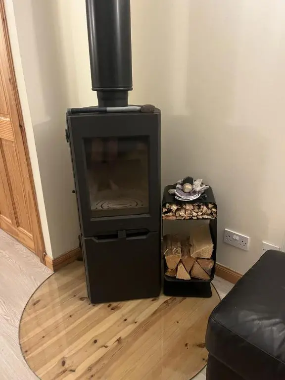 a living room with a fireplace and a television at Hopeman Cottages in Hopeman