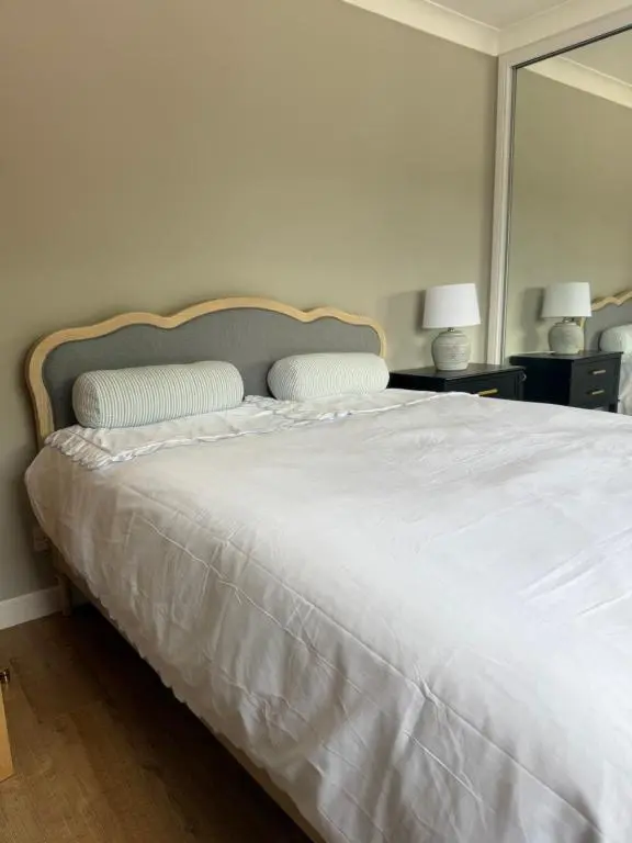 a white bed with two pillows on top of it at Culloden retreat in Culloden