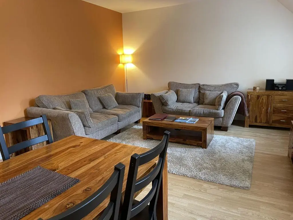 a living room with a couch and a table at Moat House 6 in Fort Augustus
