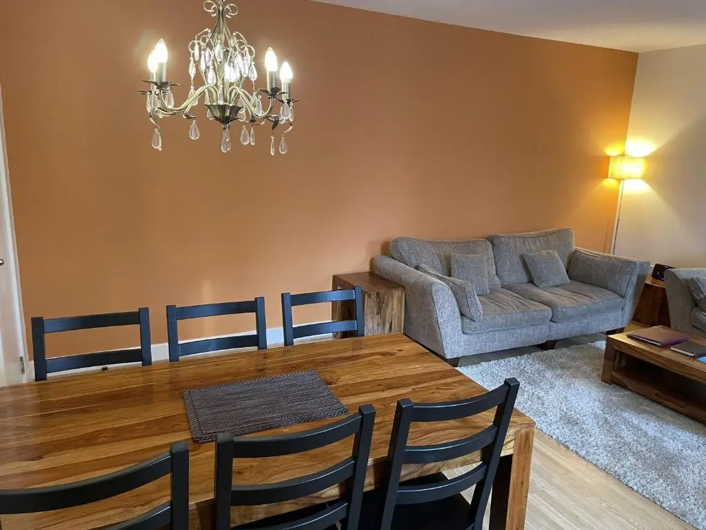 a living room with a dining table and a couch at Moat House 6 in Fort Augustus