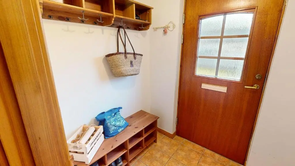 a room with a wooden door and a wooden shelf at Casa Amor in Aviemore