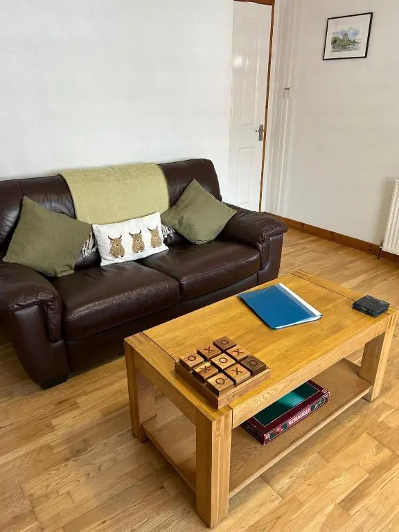 a living room with a couch and a coffee table at Cosy 1 bedroom ground floor flat, Central Inverness in Inverness