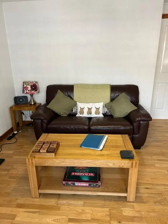 a living room with a couch and a coffee table at Cosy 1 bedroom ground floor flat, Central Inverness in Inverness