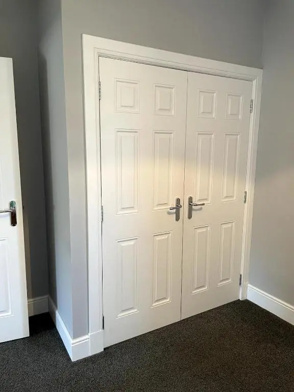a closet with a white door in a room at Spacious Flat in Aberdeenshire in Insch