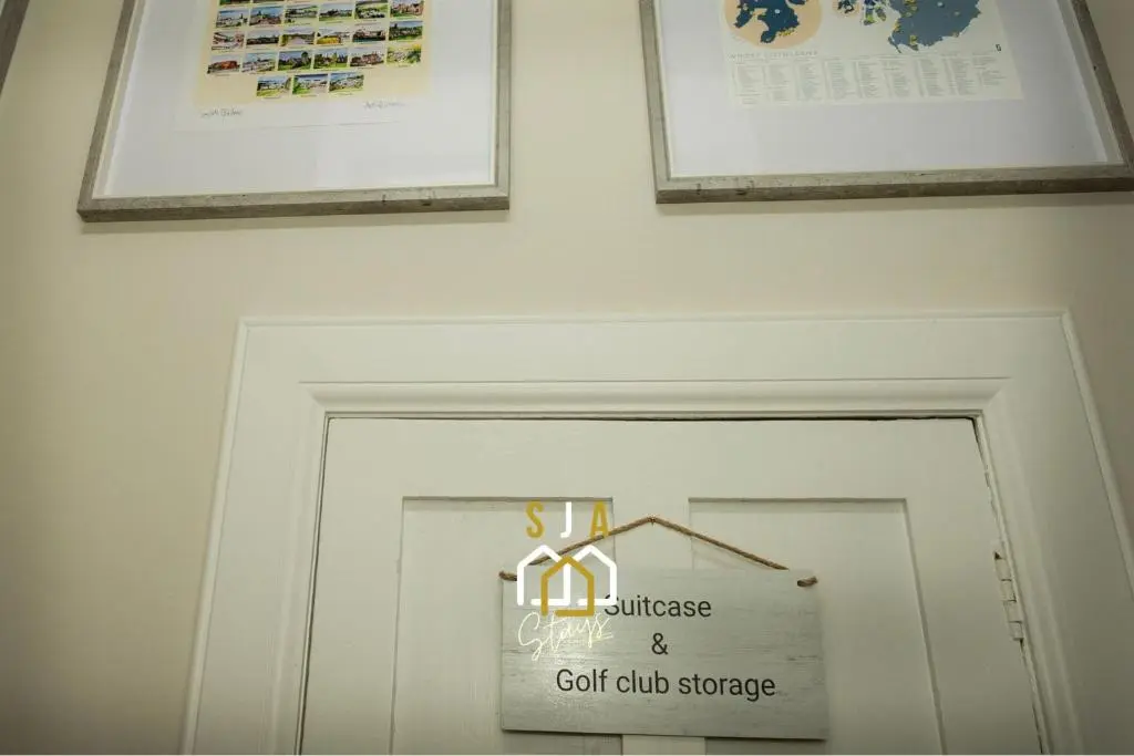 a white door with a sign above it at Beachside Cottage - SJA Stays - Modern 3 Bedroom House in Cullen