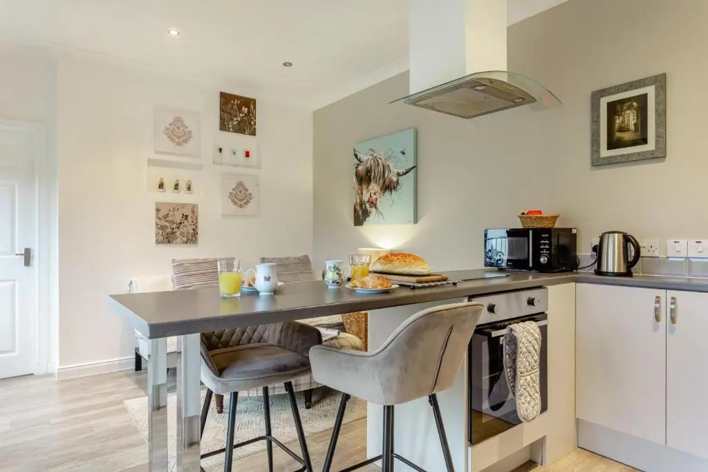 a kitchen with a counter with a table and chairs at 1 Bed in Inverness oc-a33726 in Inverness
