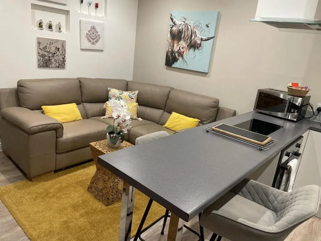 a living room with a couch and a table at 1 Bed in Inverness oc-a33726 in Inverness