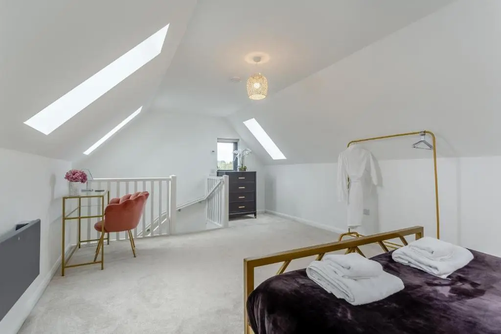 a white room with a bed and a chair at 1 Bed in Daviot oc-c33520 in Daviot