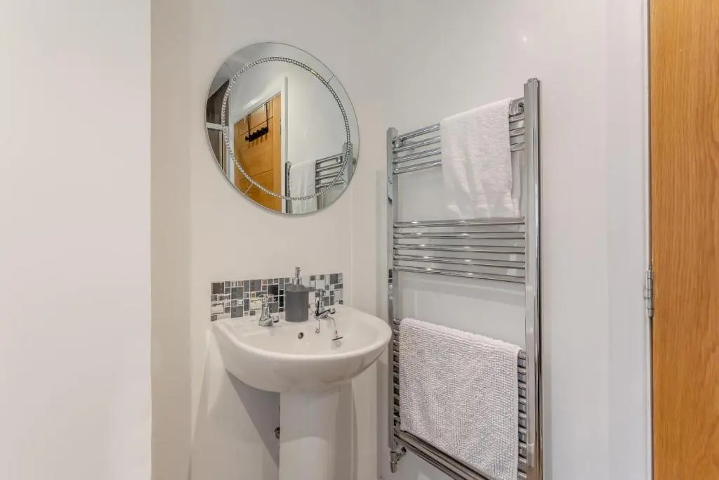 a white bathroom with a sink and a mirror at 1 Bed in Daviot oc-c33520 in Daviot