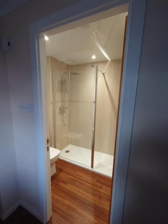 a bathroom with a shower and a toilet at 26 Two bedroom apt with private garden in Culloden