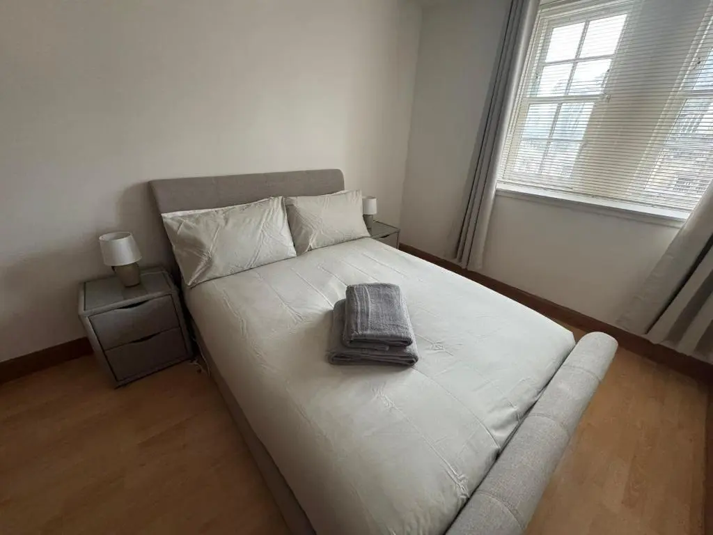 a bed with a keyboard on it in a bedroom at Church Street Apartment in Inverness