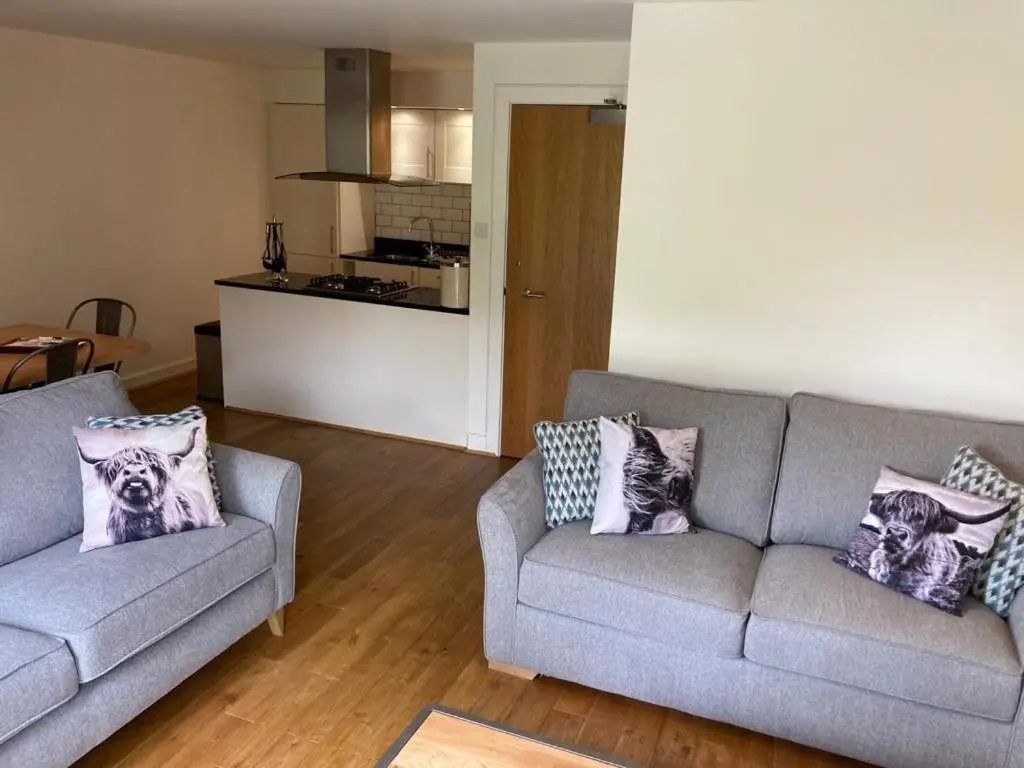 a living room with two couches and a kitchen at Raven Wing 17 - Aonach Mor in Fort Augustus
