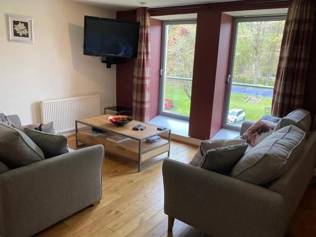 a living room with two couches and a tv at Raven Wing 17 - Aonach Mor in Fort Augustus
