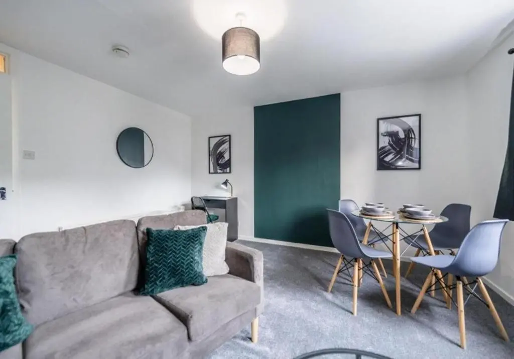 a living room with a couch and a table at Bright & Spacious 2BR Fraserburgh for Work & Family Stays in Fraserburgh