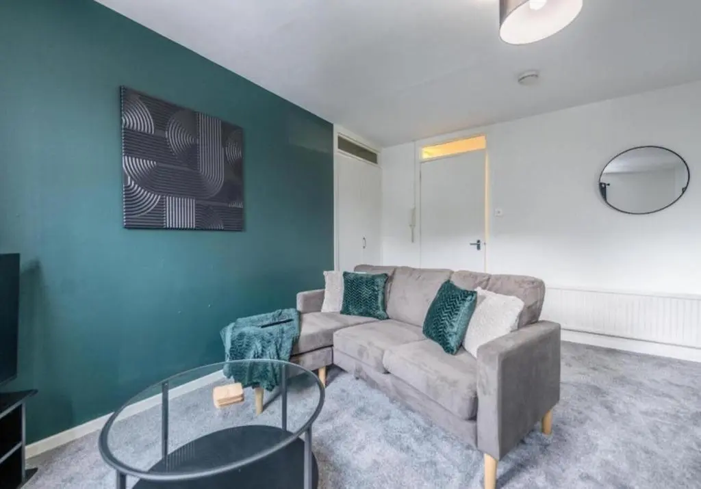 a living room with a couch and a glass table at Bright & Spacious 2BR Fraserburgh for Work & Family Stays in Fraserburgh