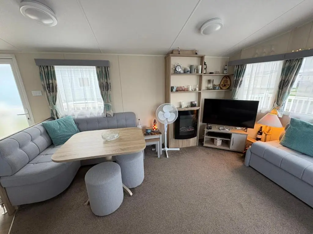 a living room with a couch and a table at Pebble Cove 74 in Lossiemouth