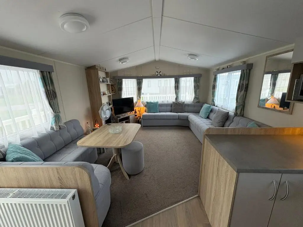 a living room with a couch and a table at Pebble Cove 74 in Lossiemouth