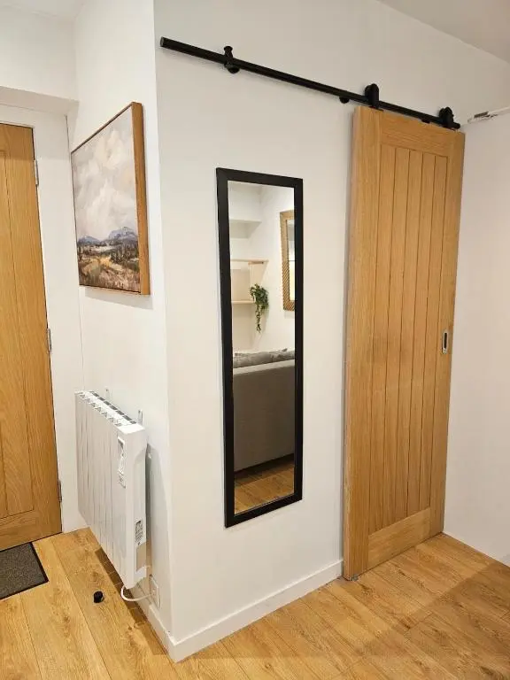 a room with a mirror and a room with a bed at Inverness City Centre Studio Flat in Inverness