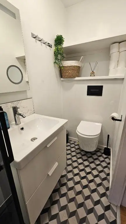a white bathroom with a sink and a toilet at Inverness City Centre Studio Flat in Inverness