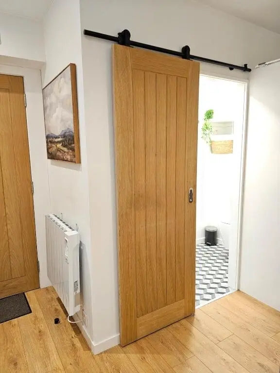 a room with a wooden door in a room at Inverness City Centre Studio Flat in Inverness