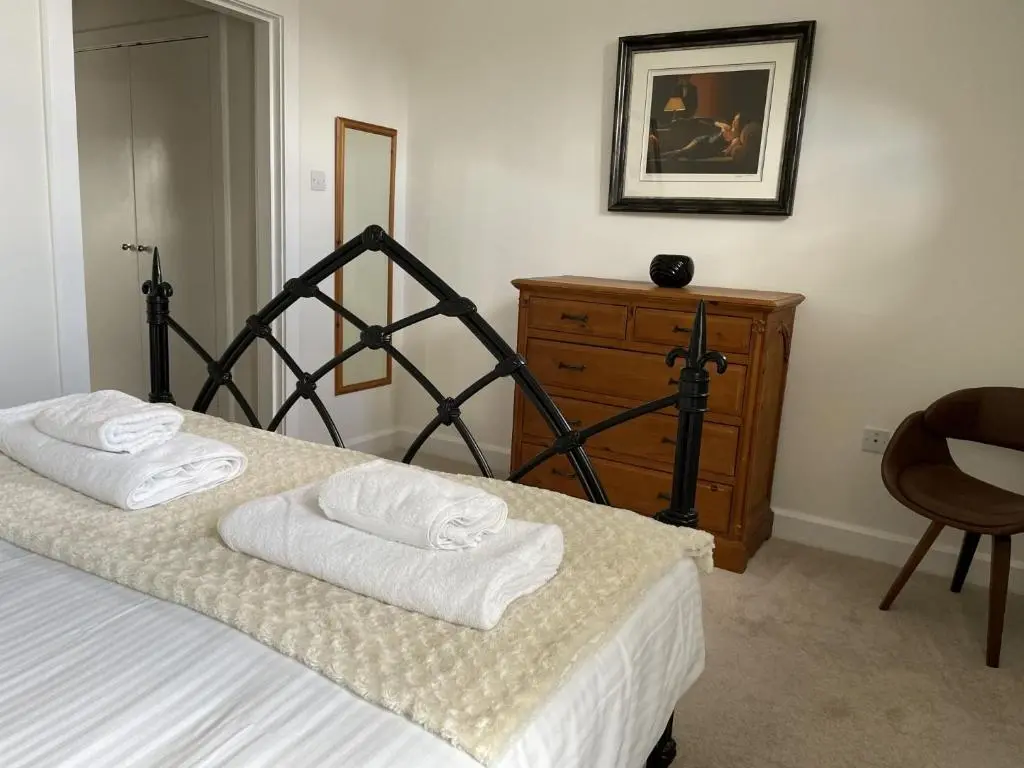 a bedroom with a bed with towels on it at Monastery 17 in Fort Augustus