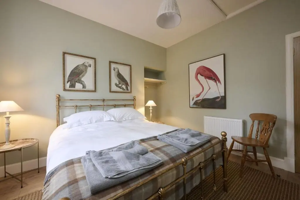 a bedroom with a bed with a towel on it at Church Cottage in Inverness