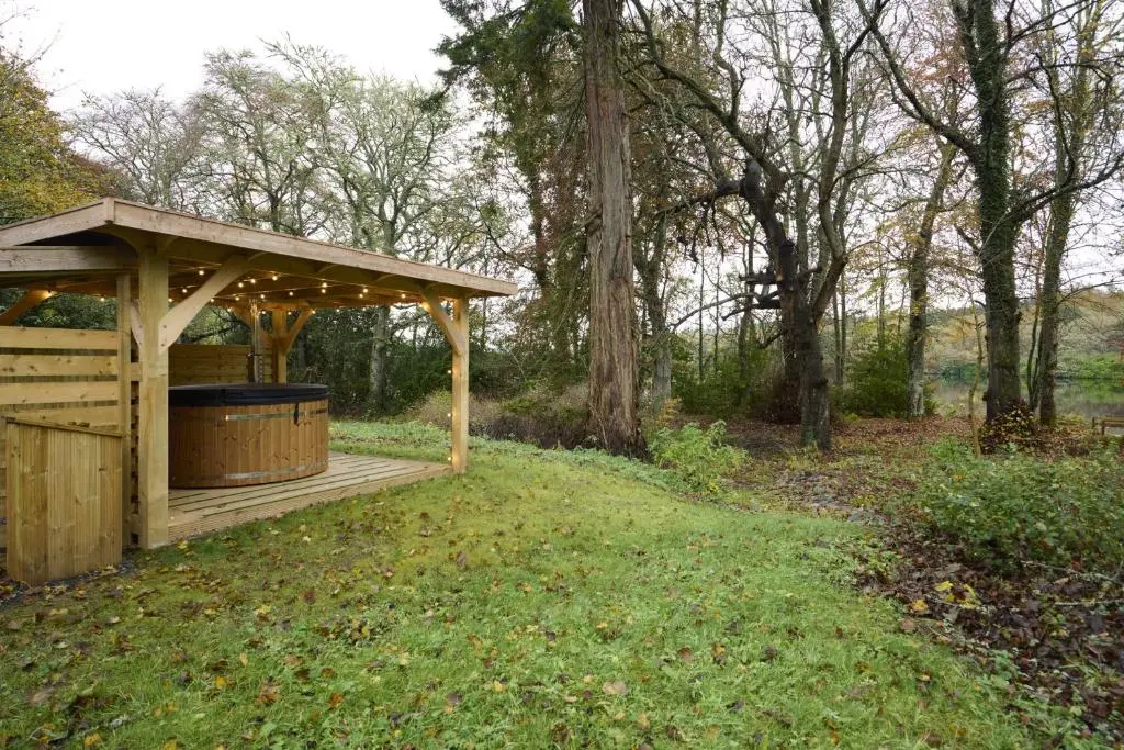 a wooden gazebo in the middle of a field at Church Cottage in Inverness
