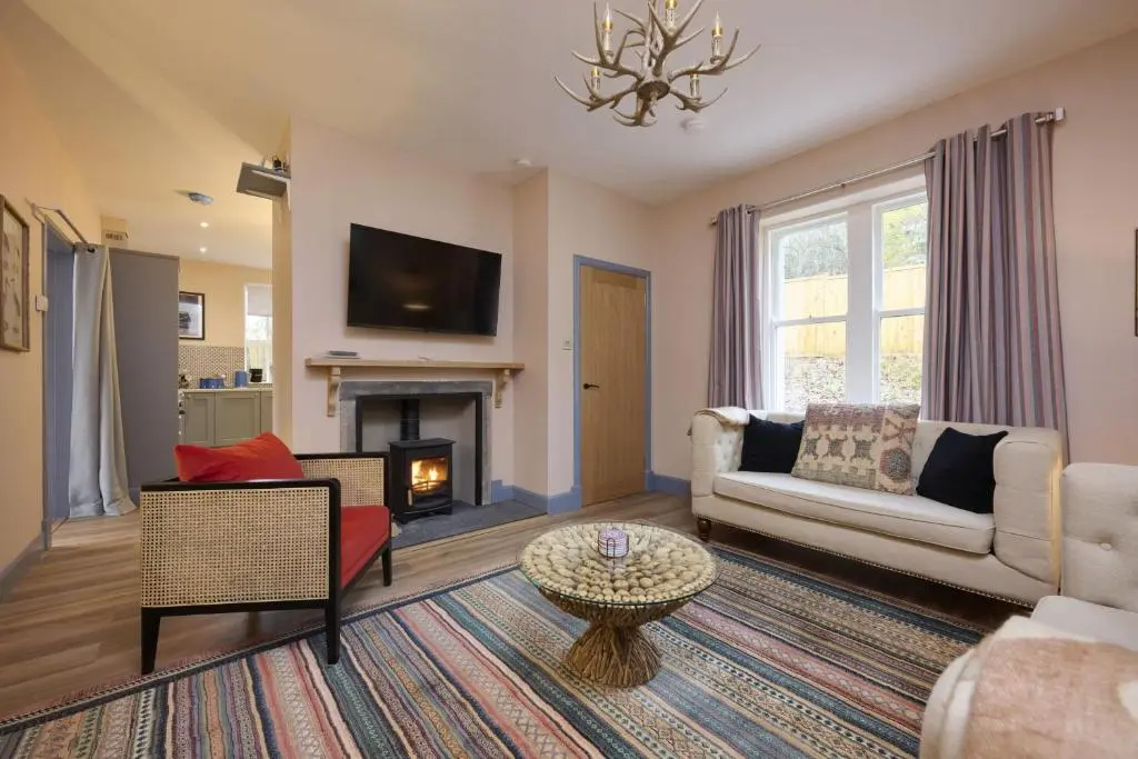a living room with a couch and a fireplace at Church Cottage in Inverness
