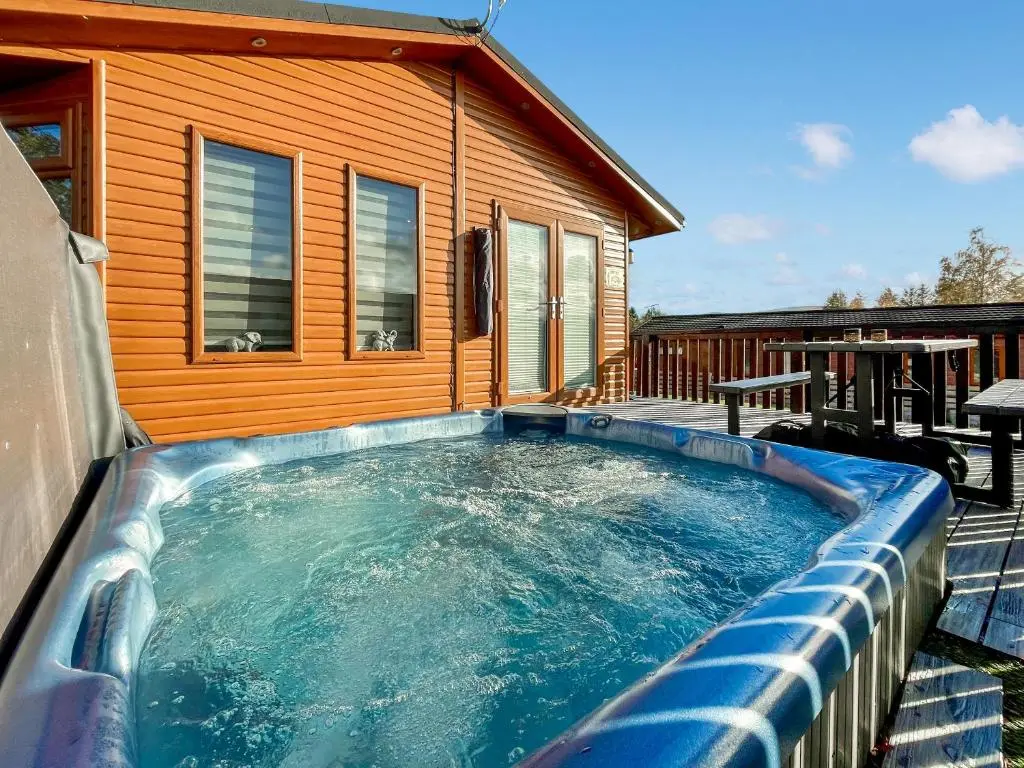 a swimming pool in front of a house at Haven Lodge - Uk50792 in Banchory