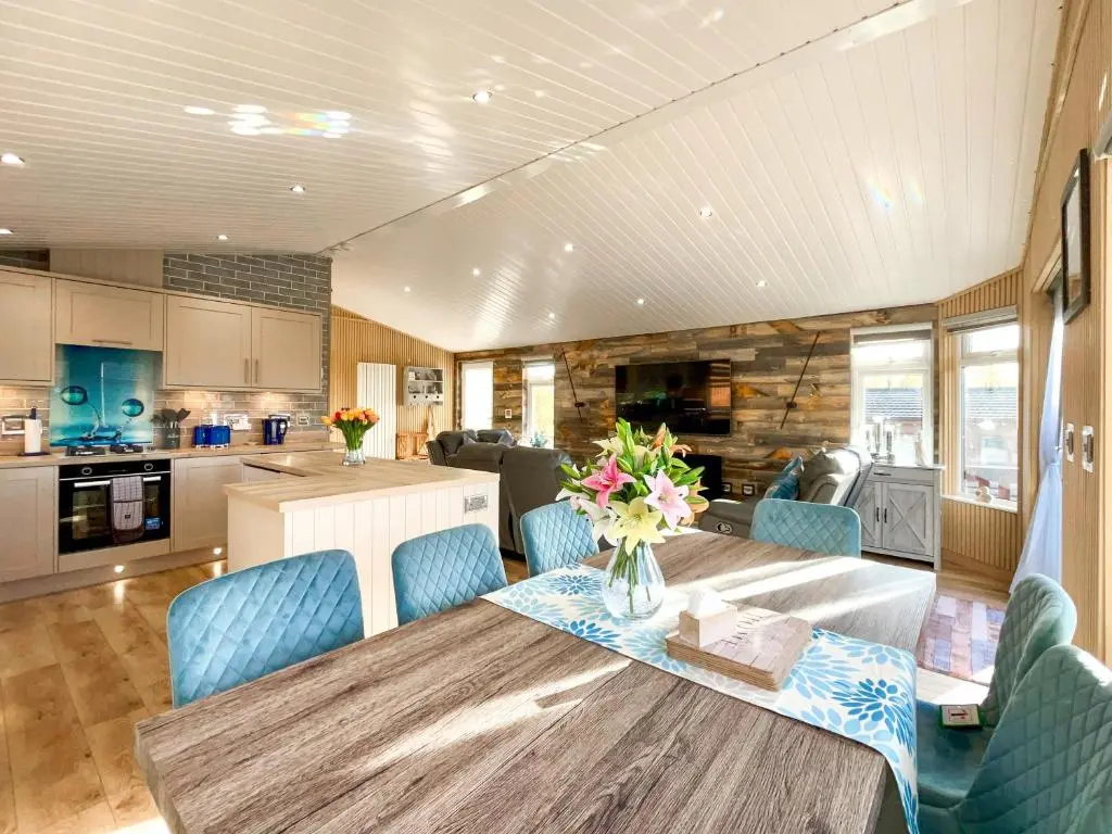 a kitchen and dining room with a table and chairs at Haven Lodge - Uk50792 in Banchory
