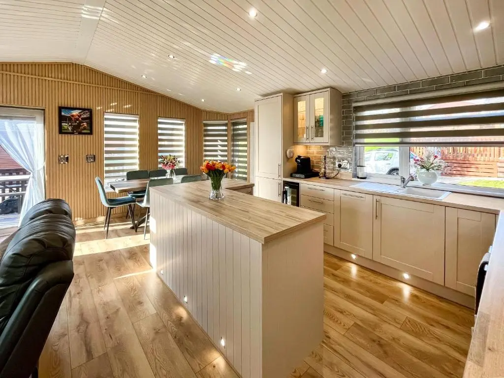a kitchen with a island in the middle of a room at Haven Lodge - Uk50792 in Banchory
