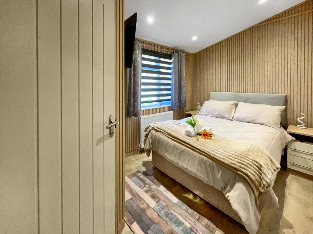 a bedroom with a bed and a window at Haven Lodge - Uk50792 in Banchory