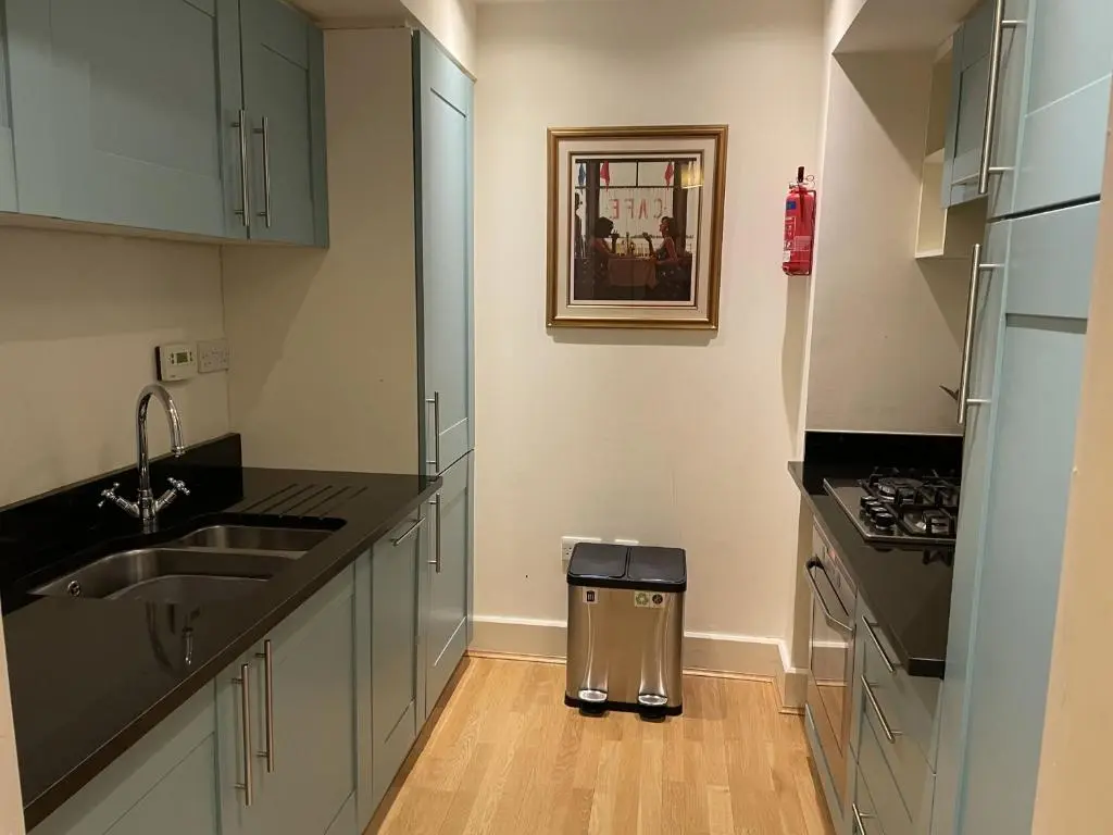 a kitchen with a sink and a trash can at Moat House 1 in Fort Augustus