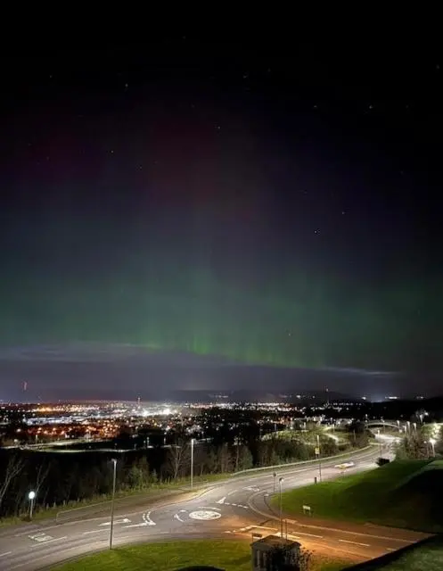 an image of a street with the aurora in the sky at High-Ness View in Inverness