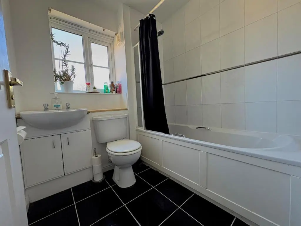 a bathroom with a toilet and a tub and a sink at Peaceful Abode in Inshes