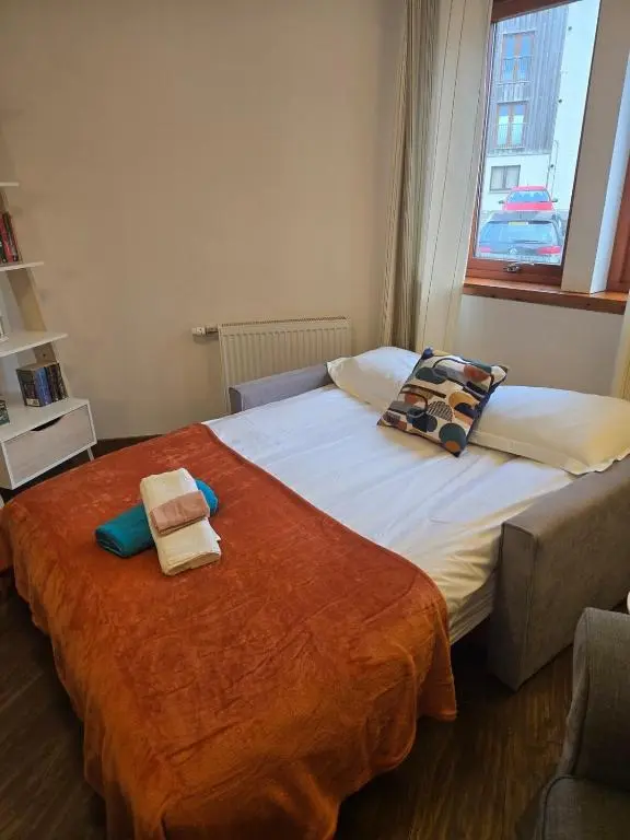 a bedroom with two beds with towels on them at The Highland Nook in South Kessock