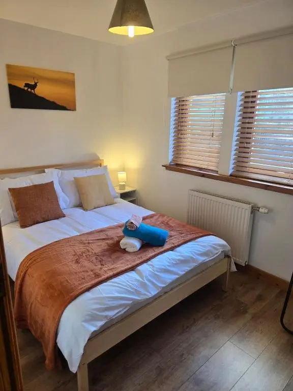 a bedroom with a bed with a stuffed animal on it at The Highland Nook in South Kessock