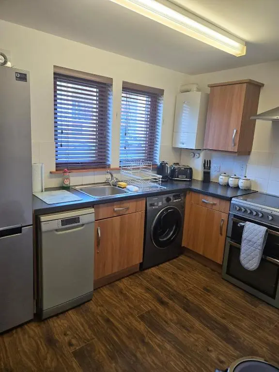 a kitchen with a washer and a sink and a dishwasher at The Highland Nook in South Kessock