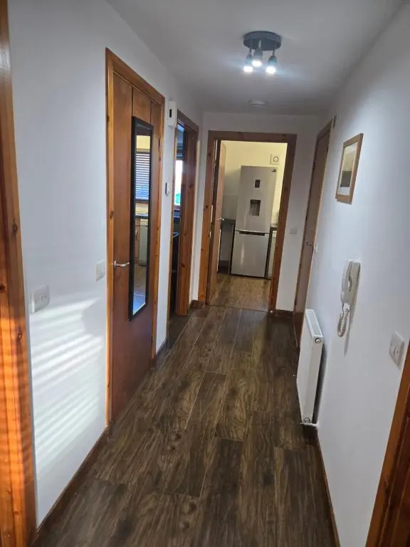 a hallway leading to a kitchen and a living room at The Highland Nook in South Kessock