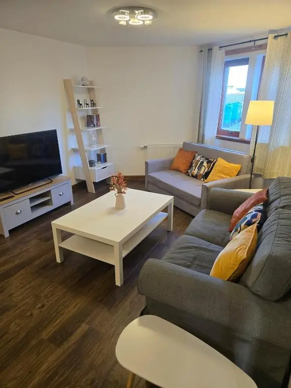 a living room with a couch and a coffee table at The Highland Nook in South Kessock