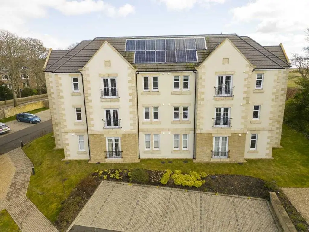 a large house with solar panels on top of it at Royal Gardens Apartment 2 in Dornoch