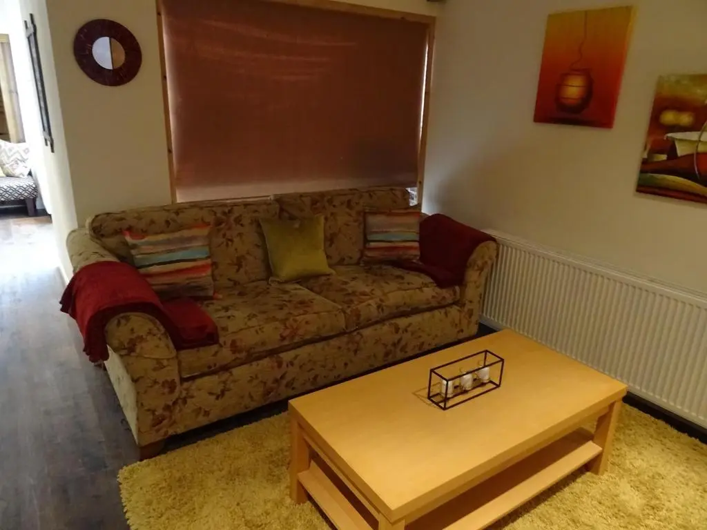 a living room with a couch and a coffee table at 'Le Studio' in Inverness