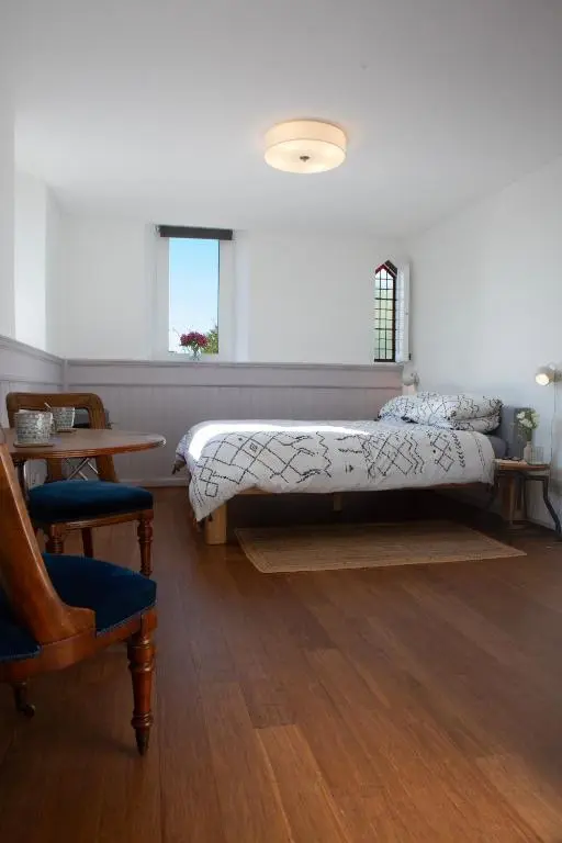 a bedroom with a bed and a chair at Old Church in Inverness