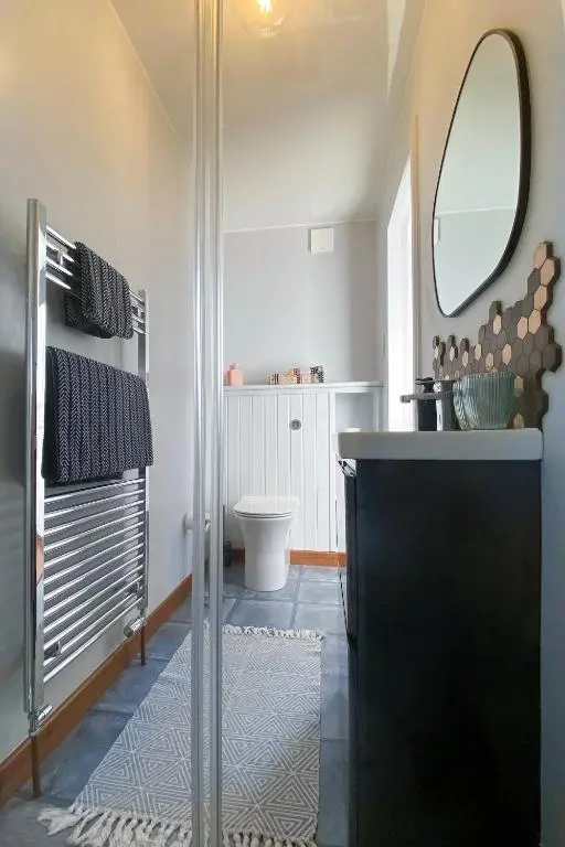 a bathroom with a shower with a sink and a toilet at Old Church in Inverness