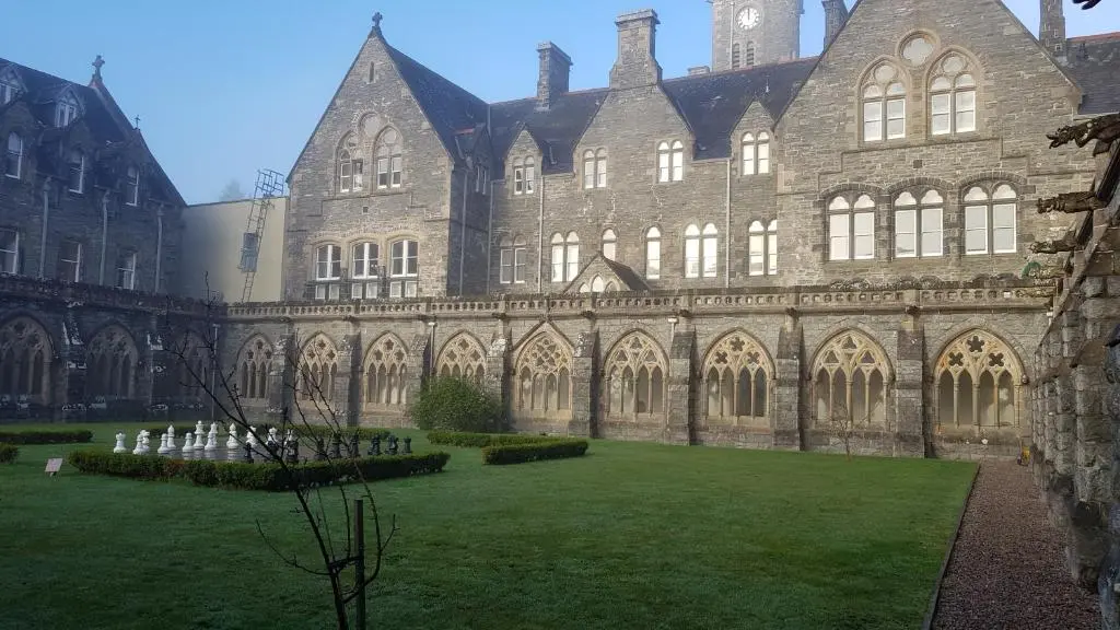 a large building with a grass yard in front of it at Old School Apartments Highland Club in Fort Augustus