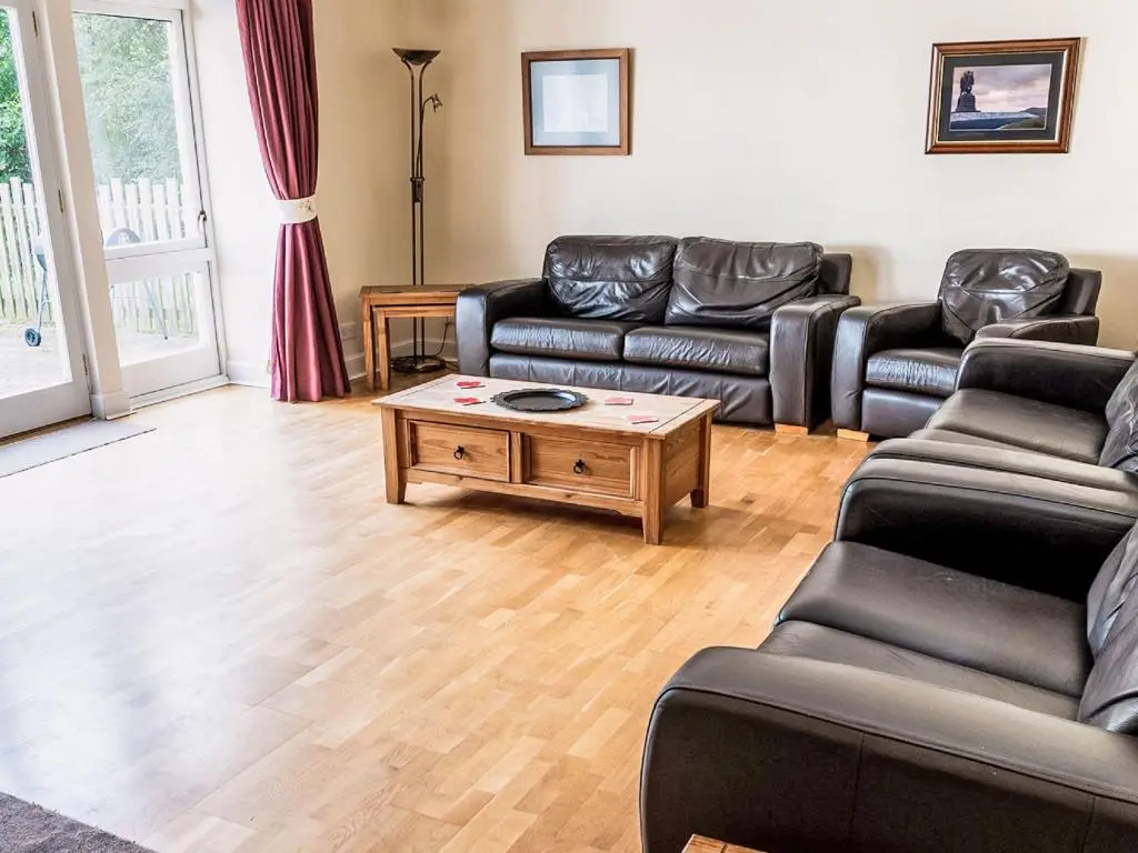 a living room with couches and a coffee table at Holiday Home Corrimony View by Interhome in Drumnadrochit