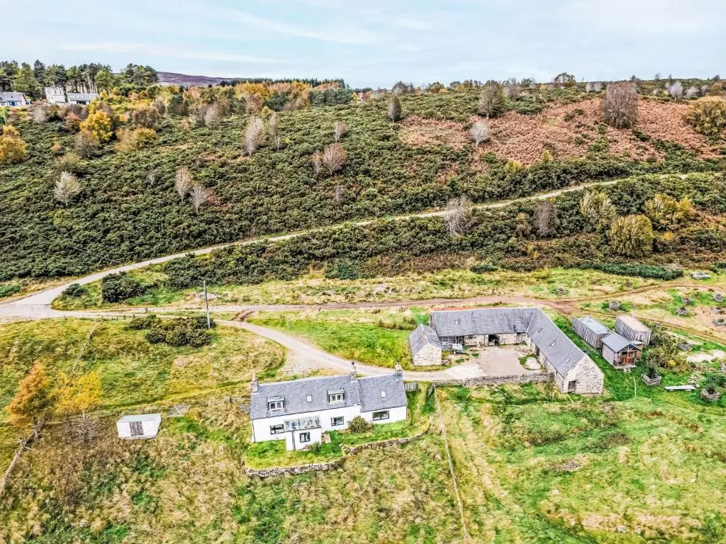 an aerial view of a house on a hill at Holiday Home Bunloit Farmhouse by Interhome in Drumnadrochit